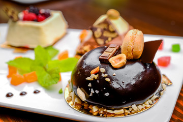 An assortment of white, dark, and milk chocolate with nuts, muffins, macaroons
