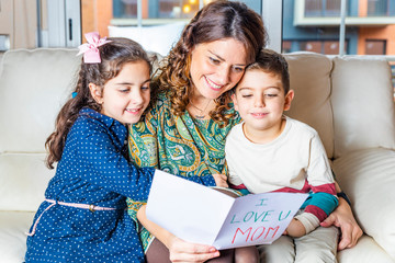 Mother and children reading a greeting card on Mother's Day