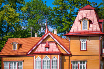 Beautiful summer house next to the forest. Wooden cottage with small towers and decorative elements. Concept of luxury lifestyle and architectural masterpiece. 