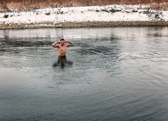 young hard-boiled boy in the cold river