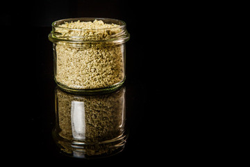 small glass jar with orange green sea salt
