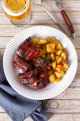 Grilled pork spare ribs with fries. Roasted sliced barbecue ribs. View from above, top studio shot, copy space