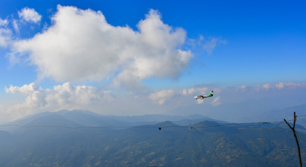 A passenger airplane flying over the mountains