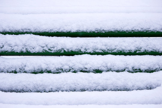 Winter landscape with snowfall and snowdrifts. snow removal in Gatchina Park. bench covered with snow.