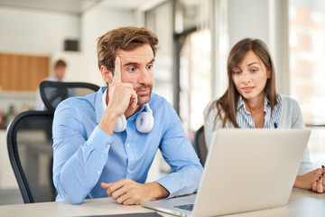 Two colleagues working on problem solving, both concentrated and not satisfied