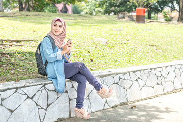 Fototapeta premium Veiled teenager at outdoor park.