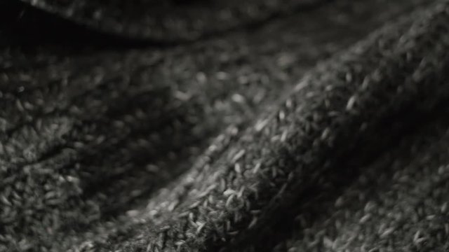Warm knitted fabric, creative background, gray texture, shallow depth of field.