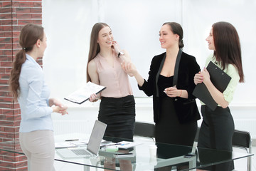business woman and her team standing in a modern office