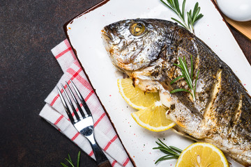 Baked dorado fish with lemon and rosemary.