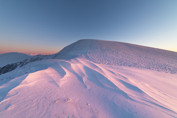 Mountain winter landscape in the Ukrainian Carpathians on the background of the sunset.
