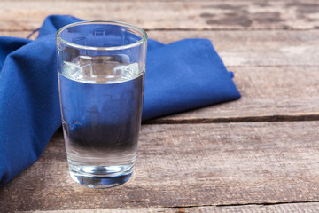 Glass of water on a wooden table