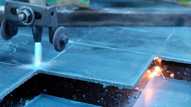 Oxycut with blue flame on a sheet of steel