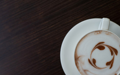 cup of coffee on black background by top view