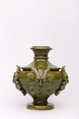 Fototapeta na wymiar Old green vase with floral motif