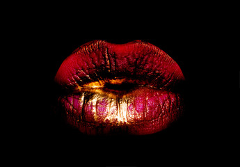 Golden red lips. Woman mouth icon. Lips isolated on black background. Luxury cosmetics concept....