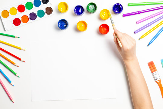 Kid Hands Painting At The Table With Art Supplies, Top View