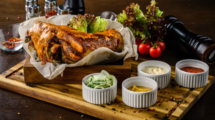 eisbein close up, Pork knuckle and fried sauerkraut and salad on wooden board