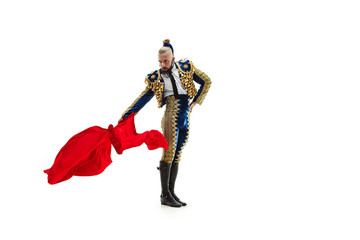 Torero in blue and gold suit or typical spanish bullfighter isolated over white studio background. The taming, achieving the goal, mortification, conquest, boss, leadership, battle, win, winner