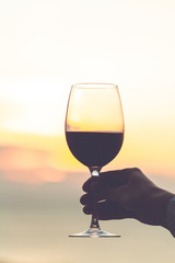 A glass wine at sunset in the evening.