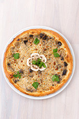 mushroom pizza on wooden background top view