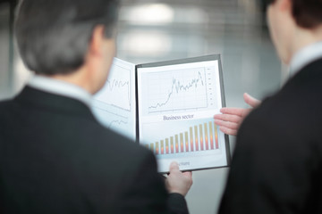 rear view.closeup of business partners discussing financial documents