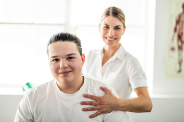 A Modern rehabilitation physiotherapy woman worker with client