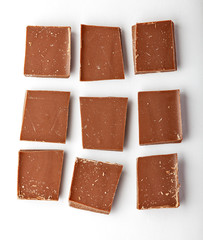 Chocolate tablets and broken pieces isolated on white background.