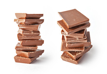 Chocolate tablets and broken pieces isolated on white background.
