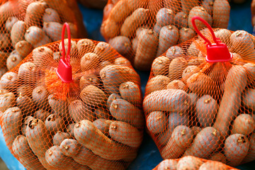 Thai ripe tamarind in the orange rope basket group for sale.