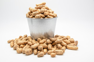 Peanuts in a tin bucket on white background.