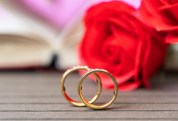 Close up wedding ring and red rose