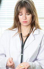 Female doctor checking medicines