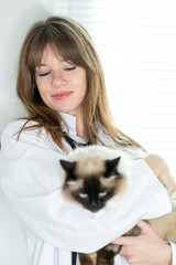 Female veterinarian with cat