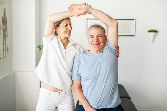 A Modern rehabilitation physiotherapy worker with senior client