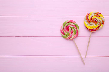Colorful lollipops on pink wooden background, Sweets