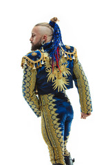 Torero in blue and gold suit or typical spanish bullfighter isolated over white studio background. The taming, achieving the goal, mortification, conquest, boss, leadership, battle, win, winner