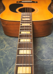 Obraz premium acoustic guitar on green marble background,music concept.