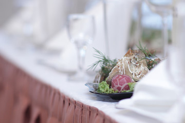 blurred image of a bottle of wine and appetizer on the table