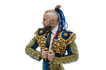 Torero in blue and gold suit or typical spanish bullfighter isolated over white studio background. The taming, achieving the goal, mortification, conquest, boss, leadership, battle, win, winner