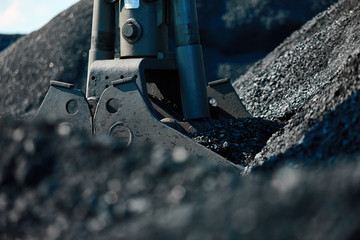 Coal loading excavator, heaps of coal