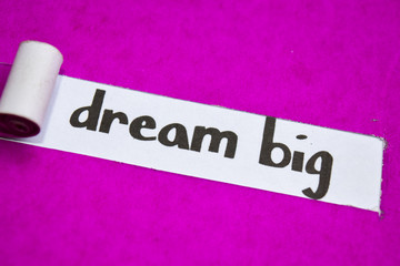 Dream Big text, Inspiration, Motivation and business concept on purple torn paper