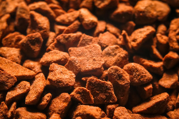 Granules of instant coffee texture background. Macro close-up photography.