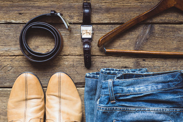 Men's clothes and accessories on wooden background. Top view
