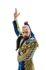Torero in blue and gold suit or typical spanish bullfighter isolated over white studio background. The taming, achieving the goal, mortification, conquest, boss, leadership, battle, win, winner
