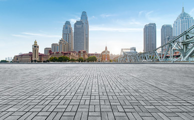 empty tiled floor and urban skyline,tianjin china.