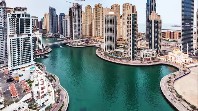 Aerial skyline of Dubai Marina, UAE, with skyscrapers in the distance. 4K timelapse.