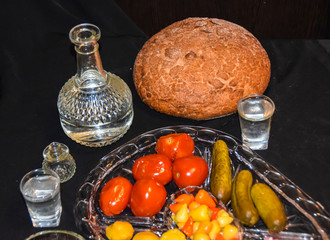Tsarist still life luxury decanter of vodka and appetizer lard pickled cucumbers tomatoes pepper...