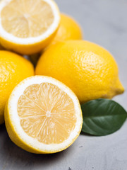 Fototapeta na wymiar Lemons on gray stone background, copy space. Organic fresh citrus fruits