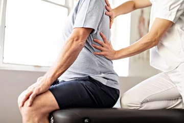  A Modern rehabilitation physiotherapy worker with senior client © Louis-Photo