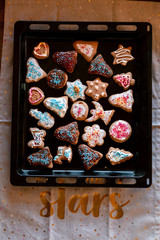 Christmas gingerbread cookies in many shapes decorated with colorful frosting